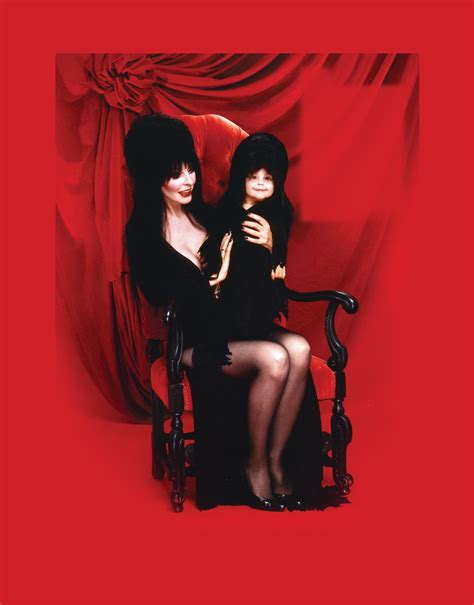 elvira celebrates halloween with revealing ‘coffin table book parade