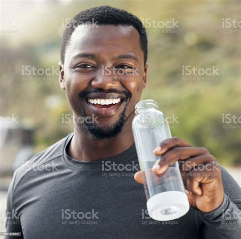Shot Of A Man Drinking Water While Out For A Workout Stock Photo