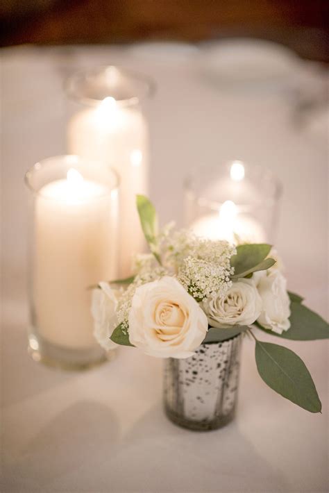 Simple Elegant Centerpiece With Candles Cylinders And A Small Arrangement Elegant