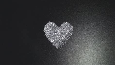 Silver Glitter Arrange To Heart Shape On Black Background