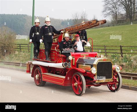 A Vintage Fire Engine From The Early 20th Century Being Demonstrated At