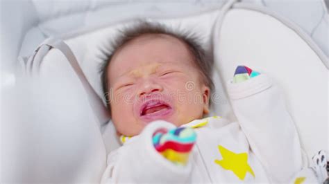 Crying Newborn Baby Boy Lying On White Bed At Homeinfant Baby