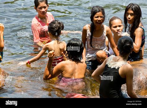 local people taking a bath in the river at the teuk chhou rapids in the province of kampot