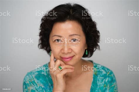 Headshot Of Mature Chinese Woman With Short Wavy Hair And Beautiful