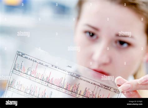 Model Released Female Scientist Holding Dna Sequencing Results Stock