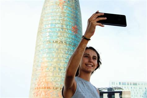 Young Girl Taking A Selfie Next To A Modern Building Stock Image