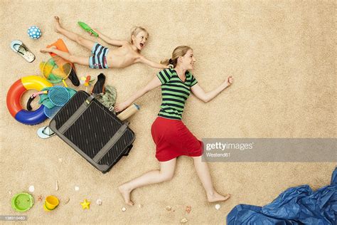 Germany Mother And Son With Toys And Baggage At Beach Photo Getty Images