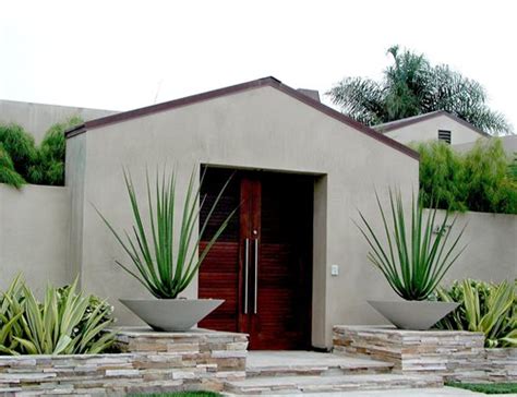 This one is interestingly off centre, filled with a single tree and large evergreen yucca. Natural Modern Gardens - Landscaping Network