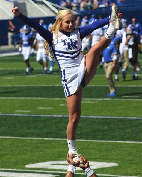 A Cheerleader Performs On The Sideline During A Football Game