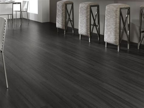 Once you've settled on hardwood flooring, you'll face another decision — stick with the classic dark hardwood look or opt for a light finish? laminate tile flooring black | Grey laminate flooring, Dark grey laminate flooring, Wooden flooring