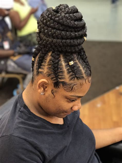 To recreate this look, part your hair in two sections. #feedinbraids braids with bun #bun #ponytailhairstyles # ...