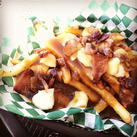 The Canadian Poutine Fries Topped With Cheese Curds Candied Bacon