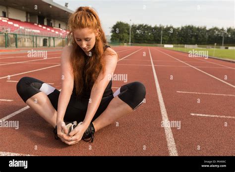 Female Athletic Exercising On Running Track Stock Photo Alamy