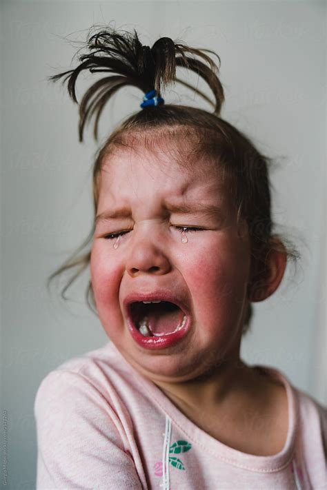 Crying Toddler Girl With Topknot By Stocksy Contributor Giorgio
