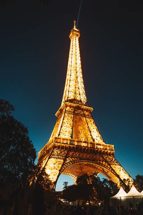 Distant lights are dim at night, and the city of paris is no exception. Eiffel Tower at night photo - Free Architecture Image on ...