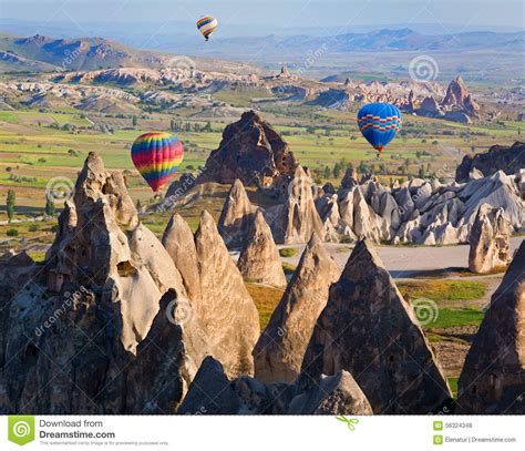 Hot Air Balloon Flying Over Rock Landscape At Cappadocia Turkey Stock