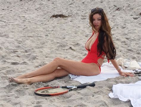 Alicia Douvall Spills Out Of Sexy Red Swimsuit As She Relaxes On The