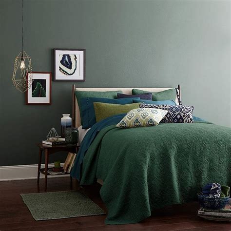 Grey pea green wall decor. Dark grey-green walls and bedding in range of muted shades (moss, teal, and medium-dark neutral ...