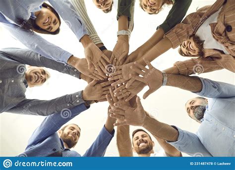 Group Of Different People Stand In A Circle And Fold Their Arms