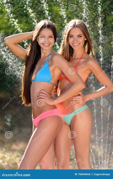 Portrait Of Two Beautiful Girls On The Beach In Summer Stock Photo Image Of Bikini Posing