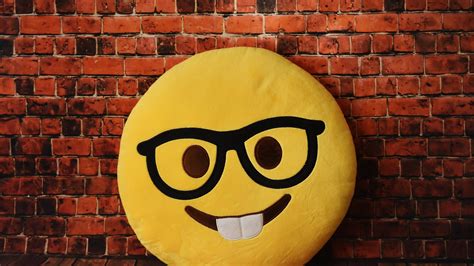 Smiley Yellow Emoji In Stone Wall Background Hd Emoji Wallpapers Hd