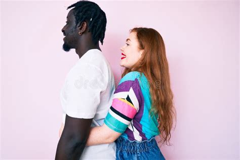 Interracial Couple Wearing Casual Clothes Looking To Side Relax Profile Pose With Natural Face