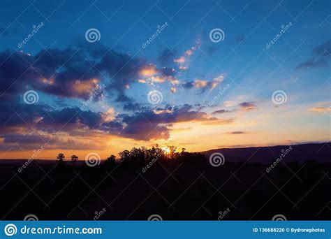 Aerial View Of A Countryside`s Sunset With Sunbeams From Forest Stock