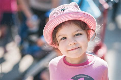 Portrait Of A Cute Little Girl Wearing A Pink Hat By Stocksy