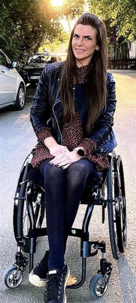 A Woman Sitting In A Wheel Chair On The Street