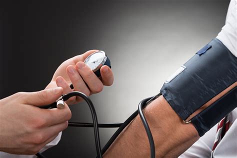 Doctor Checking Blood Pressure Of A Patient Stock Photo Download