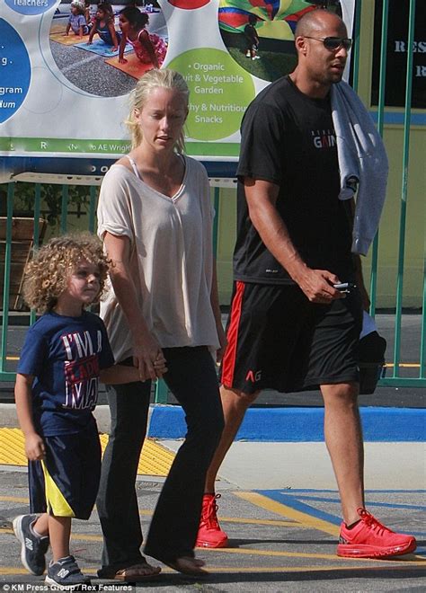 kendra wilkinson and hubby hank baskett grin broadly as they leave dmv after reporting her car