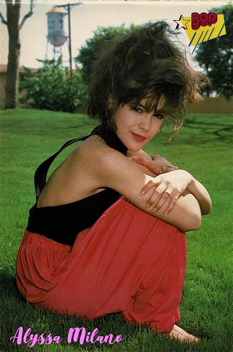 Alyssa Milano Sitting On Lawn Wearing A Black Blouse And Red Pants From September 1987 Issue Of