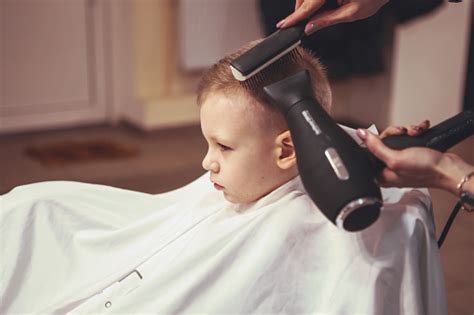 Hairdressers Hands Making Hairstyle To Little Boy Close Up Fashionable