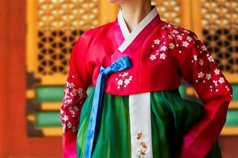 the woman wearing colorful hanbok korean traditional dress in the oriental flower background