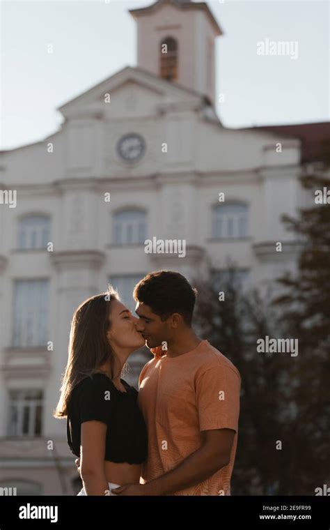 Young Couple Kissing In Front Of The Blurred Building With Copyspace Couple In Love In The City