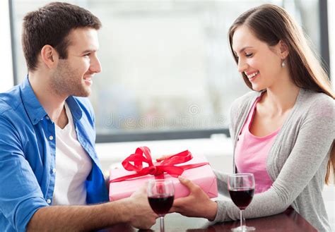 Teen brunettes love giving blowjobs. Man Giving Woman Gift At Cafe Stock Photo - Image of glass ...