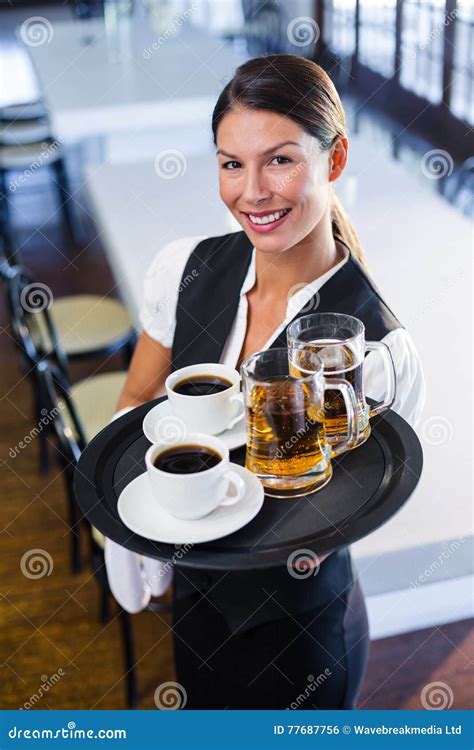 Waitress Holding Serving Tray With Coffee Cup And Pint Of Beer Stock