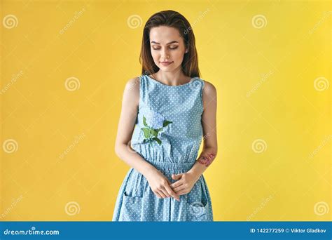 portrait of shy smiling beautiful woman looking down on yellow background stock image image of