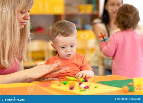 Kindergarten Kid Learning With Teacher In Nursery Stock Photo Image