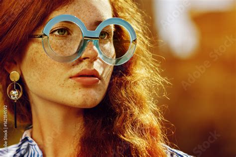 Outdoor Close Up Portrait Of Young Beautiful Fashionable Redhead Girl