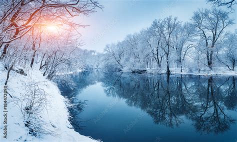 Winter Forest On The River At Sunset Colorful Landscape With Snowy