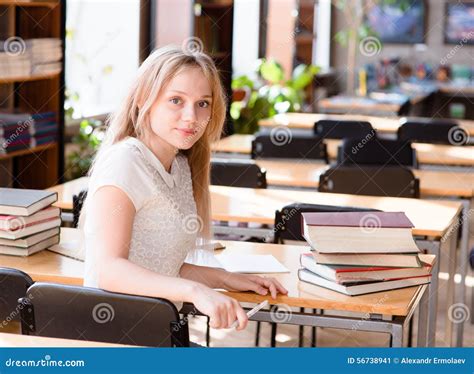 Portrait Of A Pretty Female Student Studying In Library Stock Image