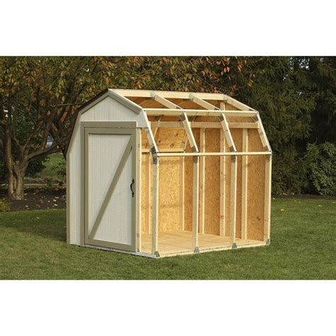 A Small Shed With The Door Open On Grass