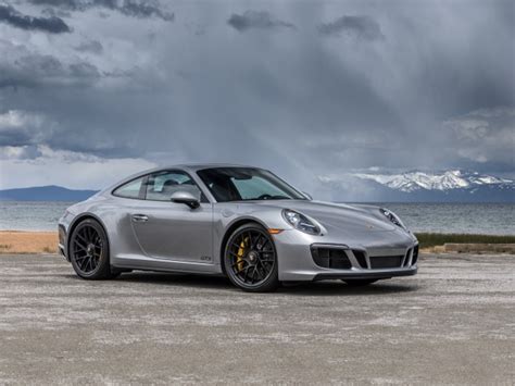 Silver Car Porsche 911 Carrera 4 Gts Coupe In The Background Of A