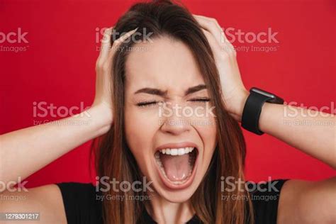 Photo Of Brunette Woman Emotionally Screaming And Grabbing Her Head In Fear Or Frustration