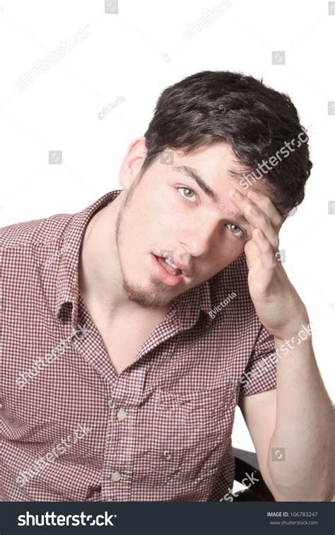 Tired Or Overwhelmed Teenager Male With Hand To His Forehead Isolated