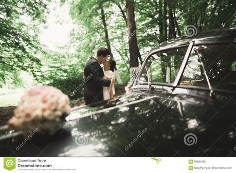 Beautiful Wedding Couple Posing Near Splendid Retro Car Stock Image