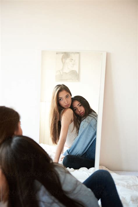 Two Girlfriends Looking In The Mirror While Hugging By Guille Faingold