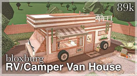 The Rv Camper Van House Is Made Out Of Wood And Has An Attached Porch