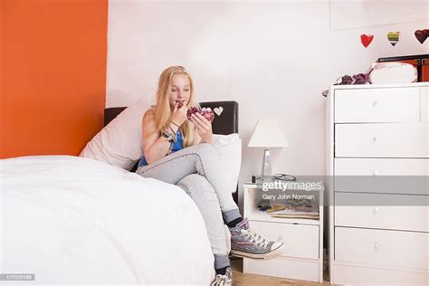 Teenage Girl In Her Bedroom Putting On Lipstick Photo Getty Images